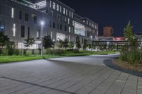 a city square in the dark with a bright street light next to the building at night