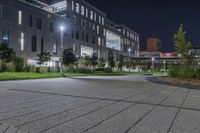 a city square in the dark with a bright street light next to the building at night