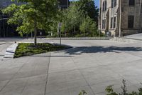 a sidewalk in front of a building with several benches and plants in the middle of it