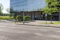 a car is stopped by the curb outside the business building on a sunny day,