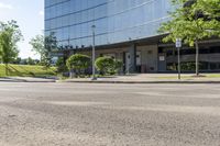 a car is stopped by the curb outside the business building on a sunny day,