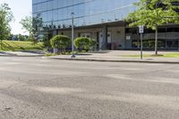 a car is stopped by the curb outside the business building on a sunny day,