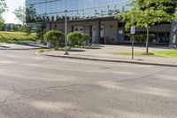 a car is stopped by the curb outside the business building on a sunny day,