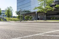 a car is stopped by the curb outside the business building on a sunny day,