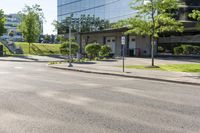 a car is stopped by the curb outside the business building on a sunny day,