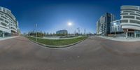 360 - view of some buildings, the sun is setting and the street is empty