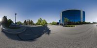 a fish eye image showing the parking lot for a business office complex and surrounding tree lined area