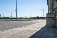 a large concrete box sitting on the side of a street under an overpass on top of a sidewalk