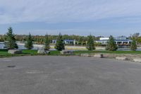 a parking lot with a stop sign and several other parked vehicles parked by the road