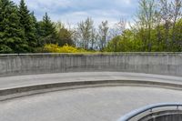 the empty concrete steps leading up to a slope with a circular area next to it