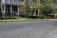 two men on motorcycles passing by a building in a residential neighborhood in springtime and sunny day