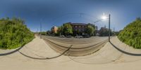 the 360 - zoom lens is of cars on a city street while the sun shines