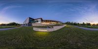 an artistic view of the outside of a building with a glass exterior that is curved