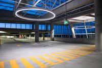 a parking garage with large circles over the ground and in the center is an exit way