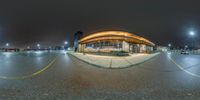 an image of an outside building with street lights at night time as a fisheye lens