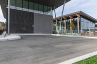 the building is near a sidewalk and a streetlight outside of it, with grass around it