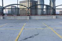 a large open area near some skyscrapers and a red fence and fencerway