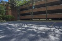 the apartment complex is empty except for visitors to use its parking space in the open