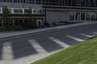 a person on a cell phone walking down the sidewalk outside a tall building with a sign for the business