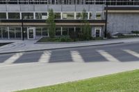 a parking meter at an office building with large windows and lots of light in the windows