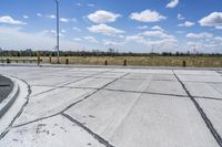 the intersection in this city is empty and vacant except for a lot of concrete parking spaces