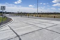 the intersection in this city is empty and vacant except for a lot of concrete parking spaces