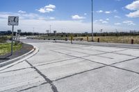 the intersection in this city is empty and vacant except for a lot of concrete parking spaces