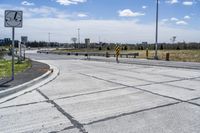 the intersection in this city is empty and vacant except for a lot of concrete parking spaces