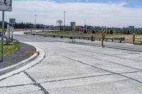 the intersection in this city is empty and vacant except for a lot of concrete parking spaces