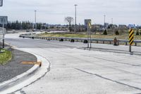 the intersection in this city is empty and vacant except for a lot of concrete parking spaces