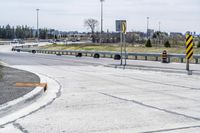 the intersection in this city is empty and vacant except for a lot of concrete parking spaces