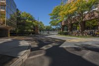 a small street surrounded by tall buildings in the city of minneapolis with trees and other plants