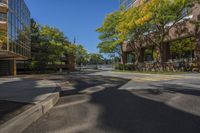 a small street surrounded by tall buildings in the city of minneapolis with trees and other plants