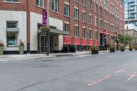 the sidewalk is painted red and blue while people walk by on the sidewalk near a building