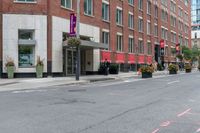 the sidewalk is painted red and blue while people walk by on the sidewalk near a building