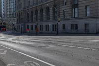 a bus traveling down the street next to tall buildings in the city with a bicycle lane