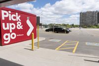 an image of a parking lot with cars parked in it and the signs advertising the place