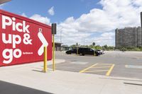 an image of a parking lot with cars parked in it and the signs advertising the place