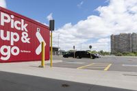 an image of a parking lot with cars parked in it and the signs advertising the place