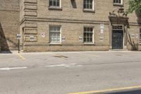 a man on a skateboard outside an old building with cars parked on it's side