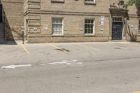 a man on a skateboard outside an old building with cars parked on it's side