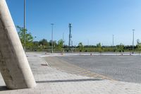 parking lot with a concrete pole and a cell phone in it's corner on an empty pavement