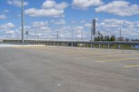 a parking lot with no vehicles parked next to it and an overpass at the top of the road