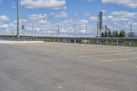 a parking lot with no vehicles parked next to it and an overpass at the top of the road