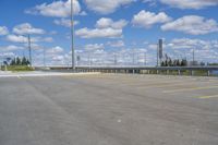 a parking lot with no vehicles parked next to it and an overpass at the top of the road