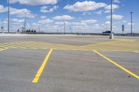 empty parking lot in large industrial area with parking spaces at the front and sky above