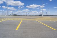 empty parking lot in large industrial area with parking spaces at the front and sky above