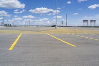 empty parking lot in large industrial area with parking spaces at the front and sky above