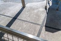 a picture looking down at the walkway and parking area in the back of a building