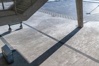 a view from the roof of an airport terminal with the sun shining down, there is a staircase going up and a stairway going up